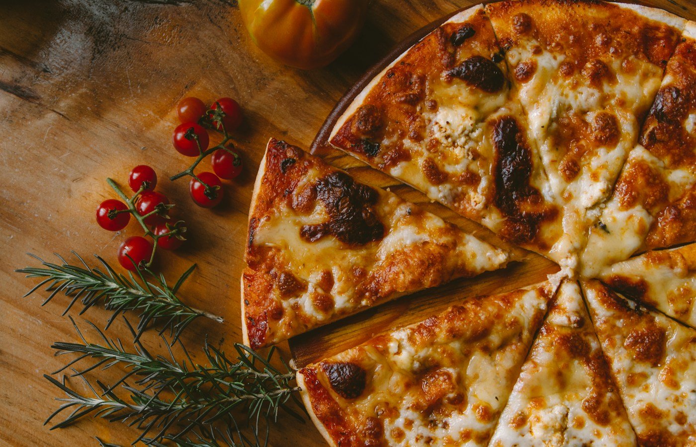 Cheese pizza on a wooden board